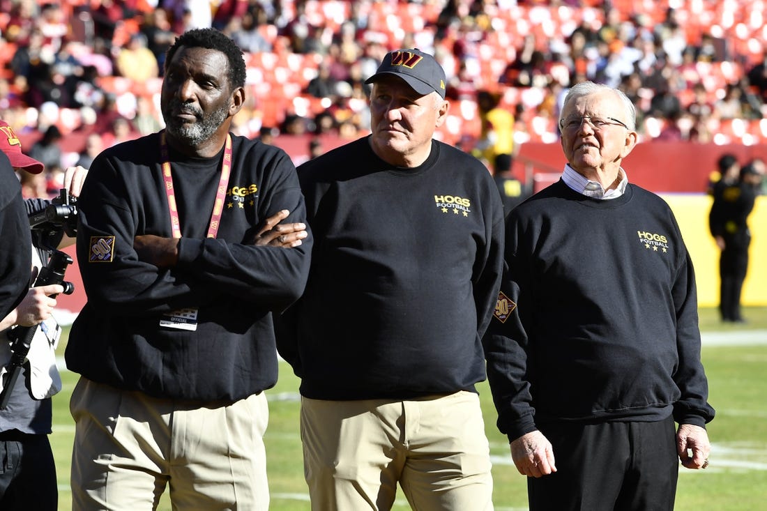 Jan 1, 2023; Landover, Maryland, USA; Washington Commanders former head coach Joe Gibbs and former quarterbacks Doug Williams (left) and Mark Rypien (center) on the field before the game at FedExField. Mandatory Credit: Brad Mills-USA TODAY Sports