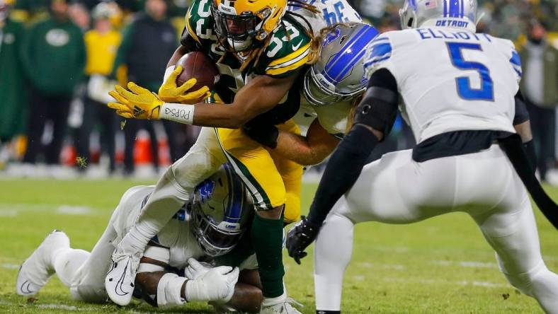 Green Bay Packers running back Aaron Jones (33) is tackled by Detroit Lions linebacker Alex Anzalone (34) and defensive end Isaiah Buggs (96) on Sunday, January 8, 2023, at Lambeau Field in Green Bay, Wis.

Mjs Apc Packers Vs Lions 010823 023 Ttm