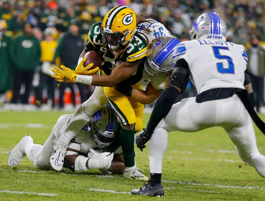 Green Bay Packers running back Aaron Jones (33) is tackled by Detroit Lions linebacker Alex Anzalone (34) and defensive end Isaiah Buggs (96) on Sunday, January 8, 2023, at Lambeau Field in Green Bay, Wis.

Mjs Apc Packers Vs Lions 010823 023 Ttm