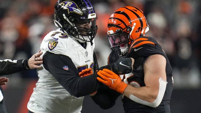 Jan 15, 2023; Cincinnati, Ohio, USA; Baltimore Ravens offensive tackle Ronnie Stanley (79) grips the jersey of Cincinnati Bengals linebacker Logan Wilson (55) after a play in the fourth quarter during an NFL wild-card playoff football game between the Baltimore Ravens and the Cincinnati Bengals at Paycor Stadium. Mandatory Credit: Sam Greene-USA TODAY Sports