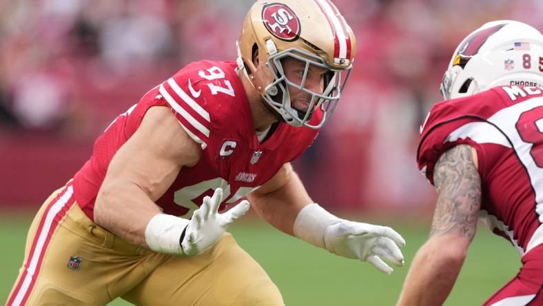 Jan 8, 2023; Santa Clara, California, USA; San Francisco 49ers defensive end Nick Bosa (97) rushes against Arizona Cardinals tight end Trey McBride (85) during the third quarter at Levi's Stadium. Mandatory Credit: Darren Yamashita-USA TODAY Sports