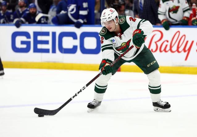Jan 24, 2023; Tampa, Florida, USA; Minnesota Wild defenseman Calen Addison (2) passes the puck against the Tampa Bay Lightning during the second period at Amalie Arena. Mandatory Credit: Kim Klement-USA TODAY Sports