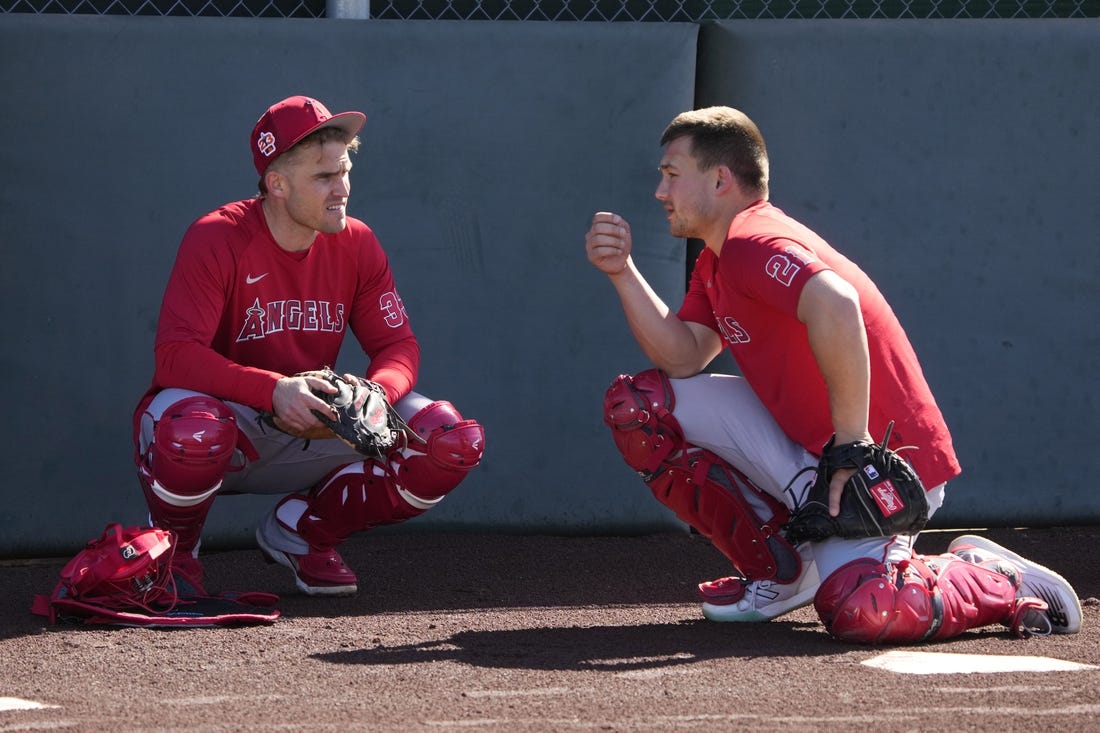 Feb 15, 2023; Tempe, AZ, USA; Los Angeles Angels catchers' Max Stassi (33) and Matt Thaiss (21) talk during spring training camp. Mandatory Credit: Rick Scuteri-USA TODAY Sports