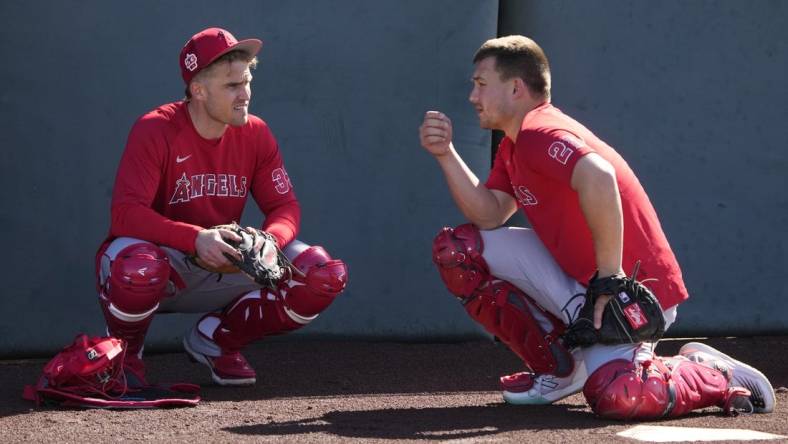 Feb 15, 2023; Tempe, AZ, USA; Los Angeles Angels catchers' Max Stassi (33) and Matt Thaiss (21) talk during spring training camp. Mandatory Credit: Rick Scuteri-USA TODAY Sports