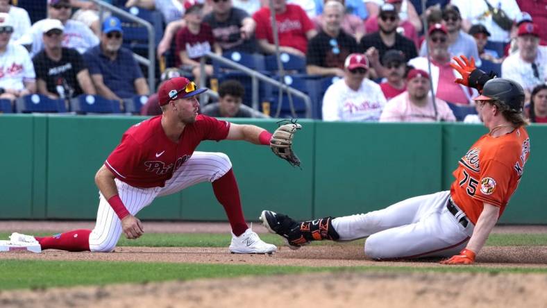 Mar 9, 2023; Clearwater, Florida, USA;  Baltimore Orioles outfielder Heston Kjerstad (75) slides safely into third as Philadelphia Phillies third baseman Alec Bohm (28) waits for the ball during the seventh at BayCare Ballpark. Mandatory Credit: Dave Nelson-USA TODAY Sports