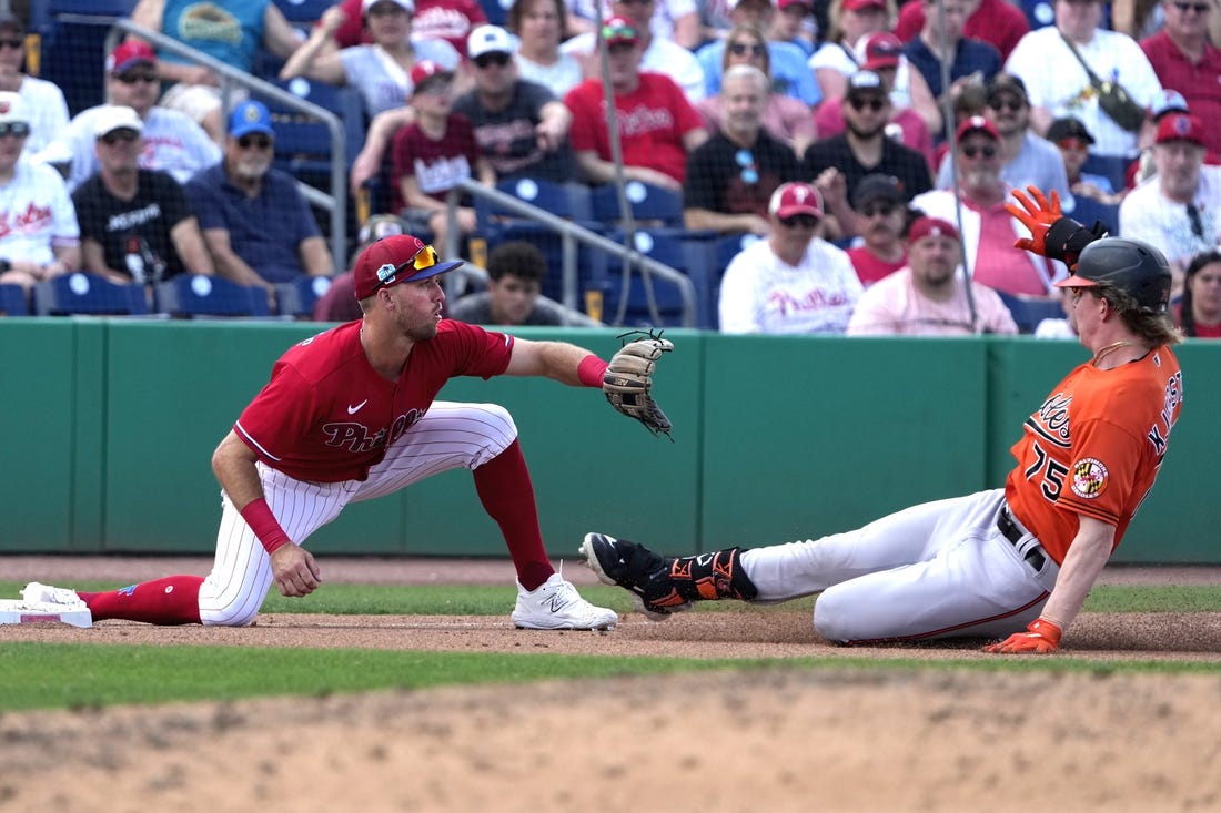 Mar 9, 2023; Clearwater, Florida, USA;  Baltimore Orioles outfielder Heston Kjerstad (75) slides safely into third as Philadelphia Phillies third baseman Alec Bohm (28) waits for the ball during the seventh at BayCare Ballpark. Mandatory Credit: Dave Nelson-USA TODAY Sports