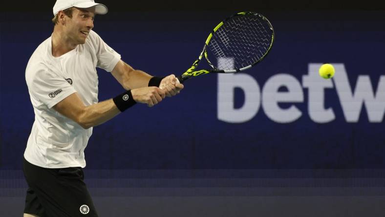 Mar 26, 2023; Miami, Florida, US; Botic van de Zandschulp (NED) hits a backhand against Casper Ruud (NOR) (not pictured) on day seven of the Miami Open at Hard Rock Stadium. Mandatory Credit: Geoff Burke-USA TODAY Sports