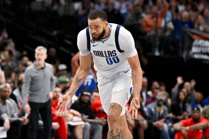 Apr 7, 2023; Dallas, Texas, USA; Dallas Mavericks center JaVale McGee (00) celebrates after making a three point shot against the Chicago Bulls during the first half at the American Airlines Center. Mandatory Credit: Jerome Miron-USA TODAY Sports