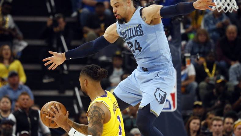 Apr 26, 2023; Memphis, Tennessee, USA; Memphis Grizzlies forward Dillon Brooks (24) defends Los Angeles Lakers guard D'Angelo Russell (1) during the second half during game five of the 2023 NBA playoffs at FedExForum. Mandatory Credit: Petre Thomas-USA TODAY Sports