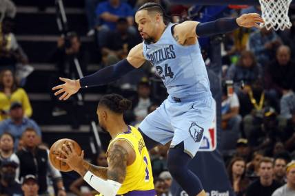 Apr 26, 2023; Memphis, Tennessee, USA; Memphis Grizzlies forward Dillon Brooks (24) defends Los Angeles Lakers guard D'Angelo Russell (1) during the second half during game five of the 2023 NBA playoffs at FedExForum. Mandatory Credit: Petre Thomas-USA TODAY Sports