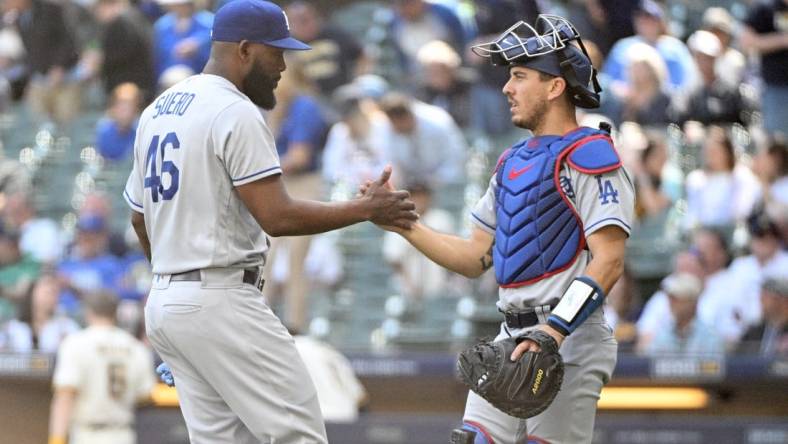 May 10, 2023; Milwaukee, Wisconsin, USA; Los Angeles Dodgers relief pitcher Wander Suero (46) and Los Angeles Dodgers catcher Austin Barnes (15) celebrate a win over the Milwaukee Brewers at American Family Field. Mandatory Credit: Michael McLoone-USA TODAY Sports