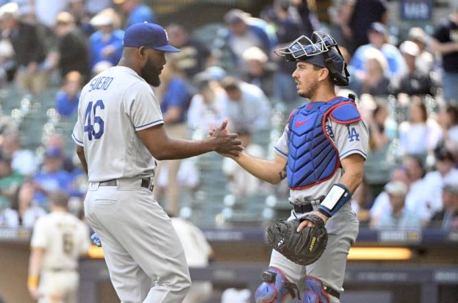 May 10, 2023; Milwaukee, Wisconsin, USA; Los Angeles Dodgers relief pitcher Wander Suero (46) and Los Angeles Dodgers catcher Austin Barnes (15) celebrate a win over the Milwaukee Brewers at American Family Field. Mandatory Credit: Michael McLoone-USA TODAY Sports