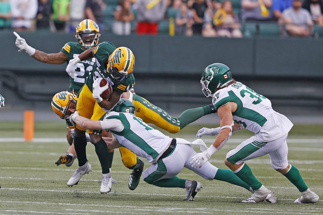 Jun 11, 2023; Edmonton, Alberta, CAN; Saskatchewan Roughriders defensive back Jaxon Ford (17) tackles Edmonton Elks running back Kevin Brown (4) during the second half at Commonwealth Stadium. Mandatory Credit: Perry Nelson-USA TODAY Sports