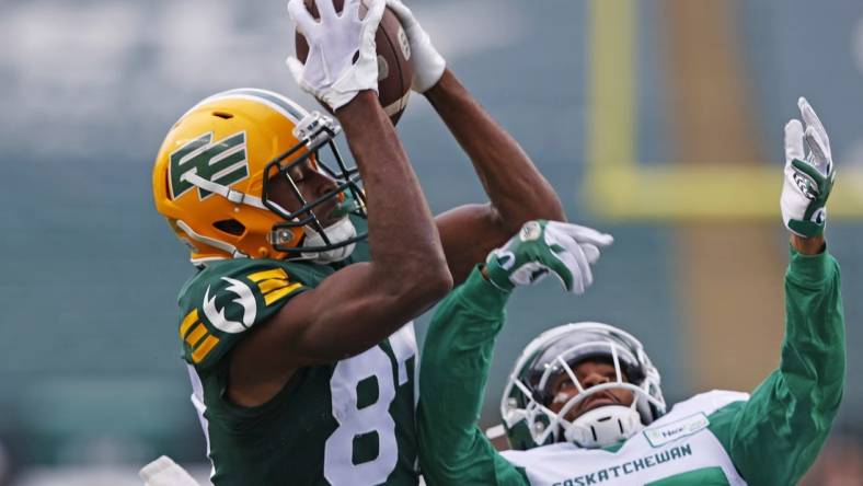 Jun 11, 2023; Edmonton, Alberta, CAN;  Edmonton Elks wide receiver Eugene Lewis (87) catches a pass over Saskatchewan Roughriders defensive back Jeremy Clark (37) for touchdown during the first half at Commonwealth Stadium. Mandatory Credit: Perry Nelson-USA TODAY Sports