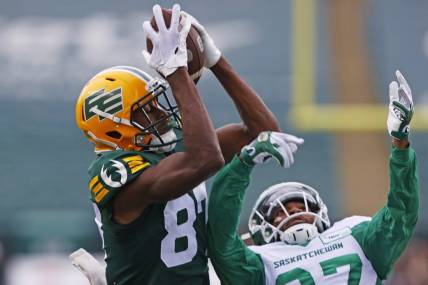Jun 11, 2023; Edmonton, Alberta, CAN;  Edmonton Elks wide receiver Eugene Lewis (87) catches a pass over Saskatchewan Roughriders defensive back Jeremy Clark (37) for touchdown during the first half at Commonwealth Stadium. Mandatory Credit: Perry Nelson-USA TODAY Sports