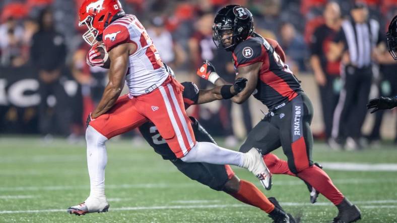 Jun 15, 2023; Ottawa, Ontario, CAN; Calgary Stampeders running back Dedrick Mills (26) runs the ball in the second half against the Ottawa REDBLACKS at TD Place. Mandatory Credit: Marc DesRosiers-USA TODAY Sports