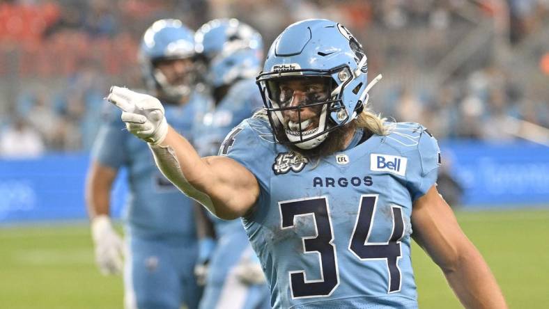 Jun 18, 2023; Toronto, Ontario, CAN;  Toronto Argonauts running back AJ Ouellette (34) gestures after running for a first down against the Hamilton Tiger-Cats in the fourth quarter at BMO Field. Mandatory Credit: Dan Hamilton-USA TODAY Sports