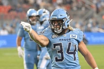 Jun 18, 2023; Toronto, Ontario, CAN;  Toronto Argonauts running back AJ Ouellette (34) gestures after running for a first down against the Hamilton Tiger-Cats in the fourth quarter at BMO Field. Mandatory Credit: Dan Hamilton-USA TODAY Sports