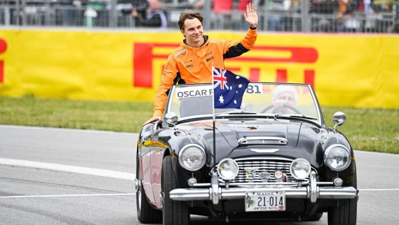 Jun 18, 2023; Montreal, Quebec, CAN; McLaren driver Oscar Piastri (AUS) parades and salutes the crowd before the Canadian Grand Prix at Circuit Gilles Villeneuve. Mandatory Credit: David Kirouac-USA TODAY Sports