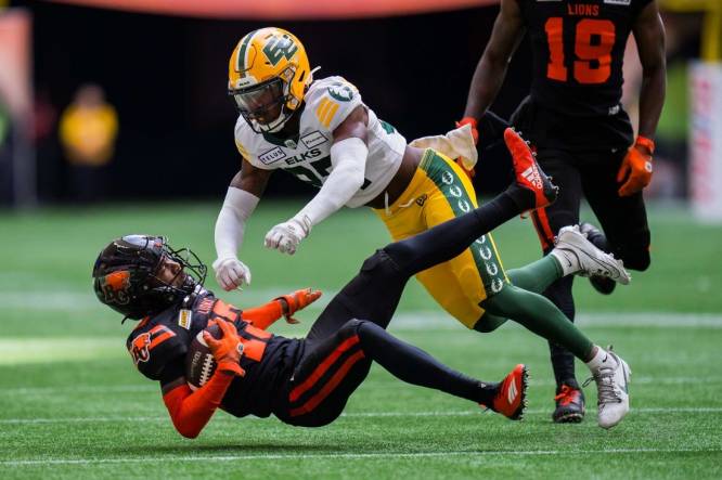 Jun 17, 2023; Vancouver, British Columbia, CAN; Edmonton Elks defensive back Dwayne Thompson II (37) tackles BC Lions receiver Alexander Hollins (13) in the first half in at BC Place. Mandatory Credit: Bob Frid-USA TODAY Sports