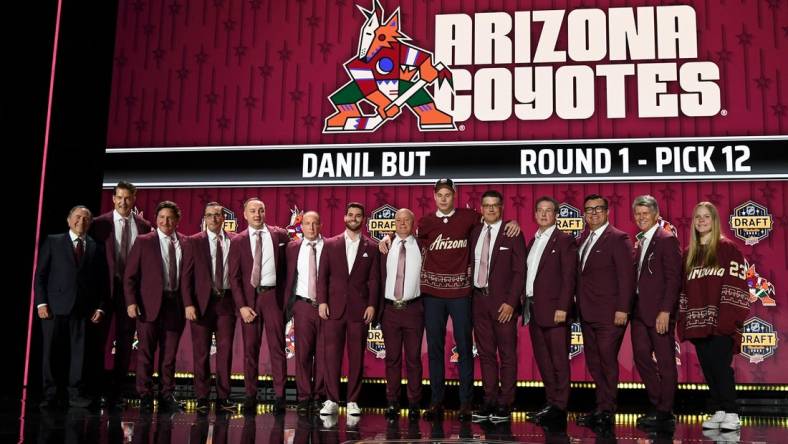 Jun 28, 2023; Nashville, Tennessee, USA; Arizona Coyotes draft pick Daniil But stands with Coyotes staff after being selected with the twelfth pick in round one of the 2023 NHL Draft at Bridgestone Arena. Mandatory Credit: Christopher Hanewinckel-USA TODAY Sports