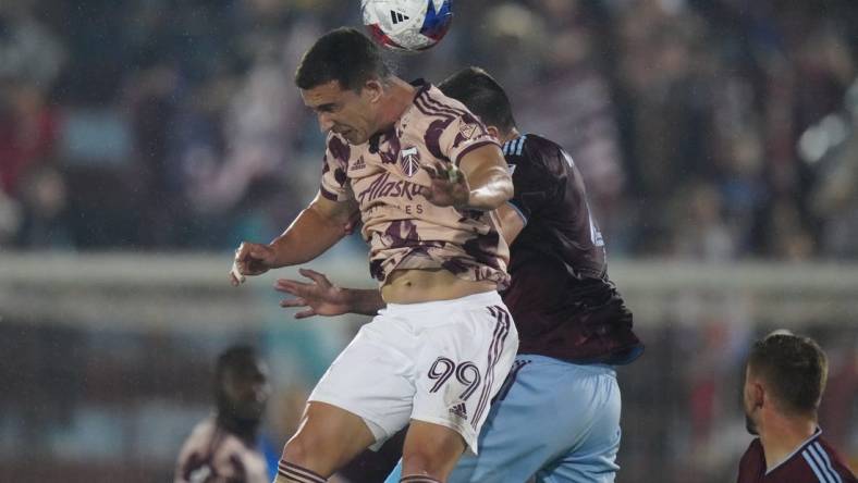 Jul 4, 2023; Commerce City, Colorado, USA; Portland Timbers forward Nathan Fogaca (99) heads the ball against Colorado Rapids defender Danny Wilson (4) during the first half at Dick's Sporting Goods Park. Mandatory Credit: Ron Chenoy-USA TODAY Sports