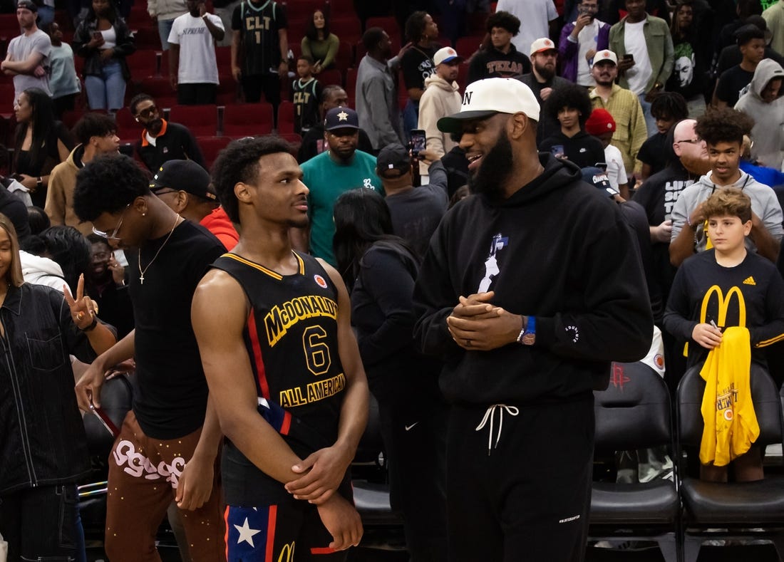 Mar 28, 2023; Houston, TX, USA; West guard Bronny James (6) with father LeBron James following the McDonald's All American Boy's high school basketball game at Toyota Center. Mandatory Credit: Mark J. Rebilas-USA TODAY Sports