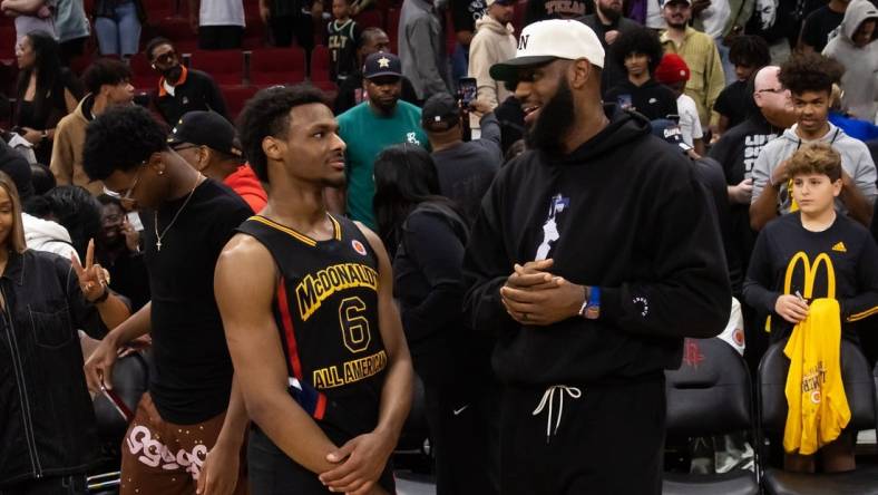 Mar 28, 2023; Houston, TX, USA; West guard Bronny James (6) with father LeBron James following the McDonald's All American Boy's high school basketball game at Toyota Center. Mandatory Credit: Mark J. Rebilas-USA TODAY Sports