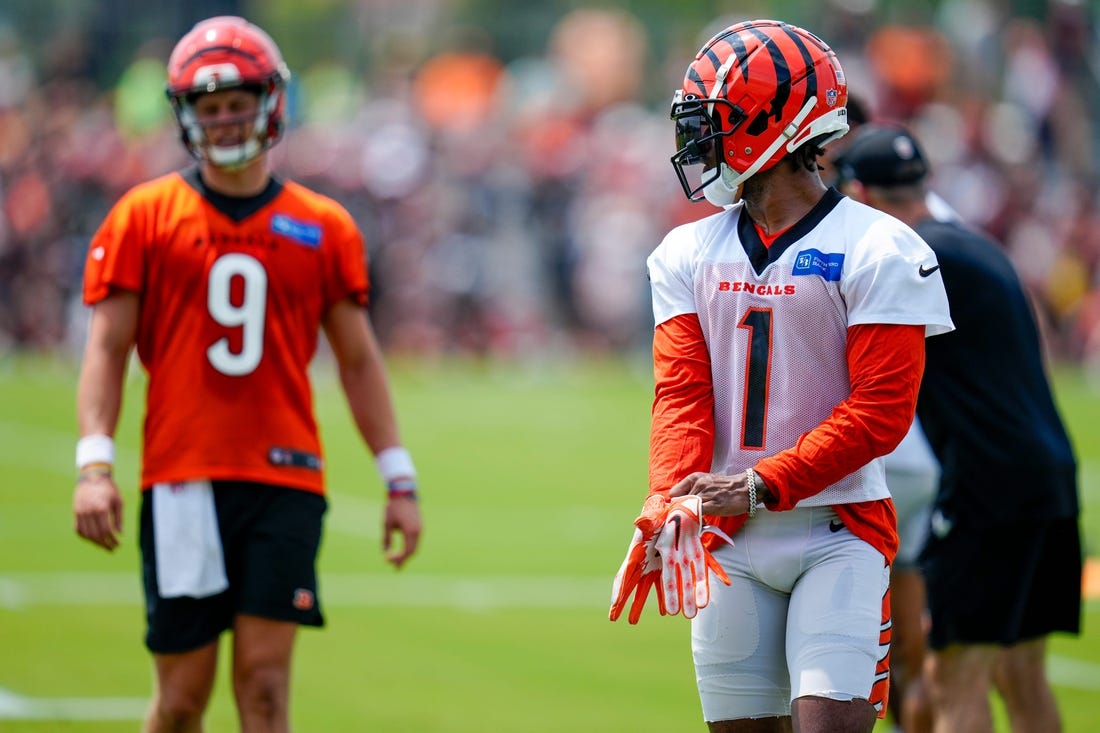 Cincinnati Bengals wide receiver Ja'Marr Chase (1) and Cincinnati Bengals quarterback Joe Burrow (9) line up before a play during a training camp practice at the Paycor Stadium practice field in downtown Cincinnati on Wednesday, July 26, 2023.