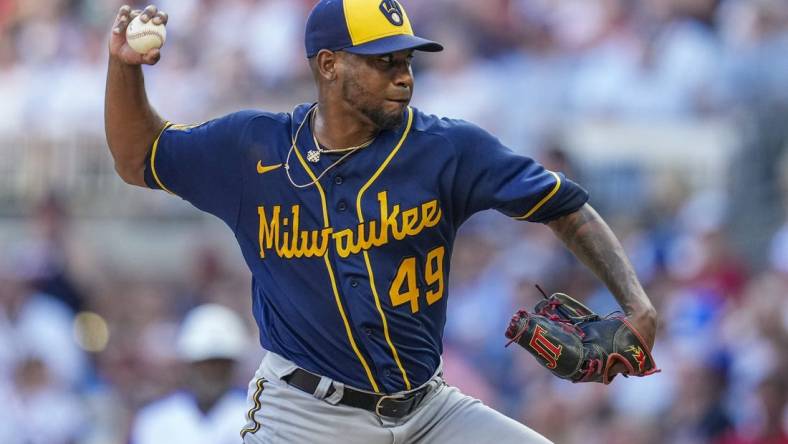 Jul 29, 2023; Cumberland, Georgia, USA; Milwaukee Brewers starting pitcher Julio Teheran (49) pitches against the Atlanta Braves during the first inning at Truist Park. Mandatory Credit: Dale Zanine-USA TODAY Sports