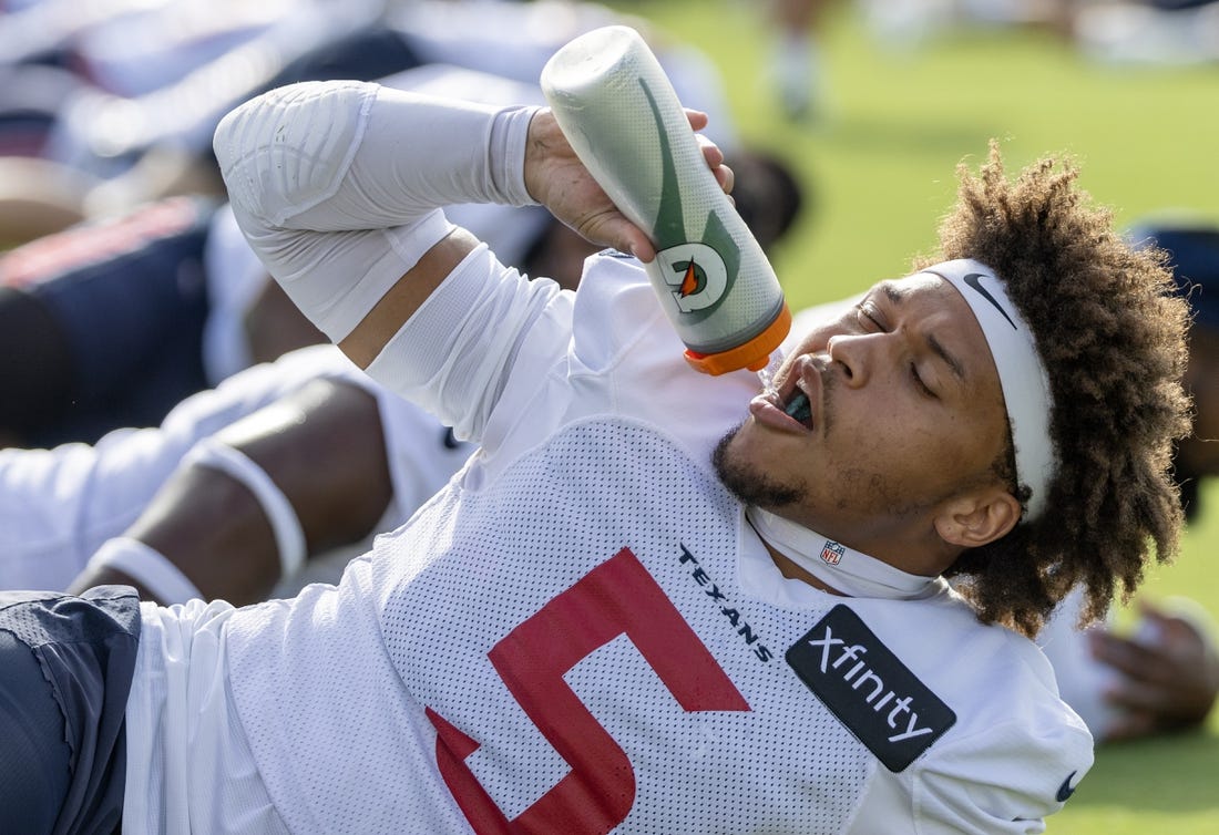 Jul 30, 2023; Houston, TX, USA; Houston Texans safety Jalen Pitre (5) takes a drink of water while warming up during training camp practice at the Houston Methodist Training Center. Mandatory Credit: Thomas Shea-USA TODAY Sports