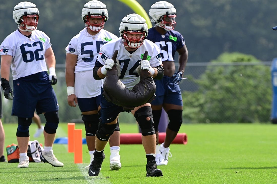 Jul 27, 2023; Foxborough, MA, USA; New England Patriots offensive tackle Riley Reiff (74) works with a weight bag during training camp at Gillette Stadium. Mandatory Credit: Eric Canha-USA TODAY Sports