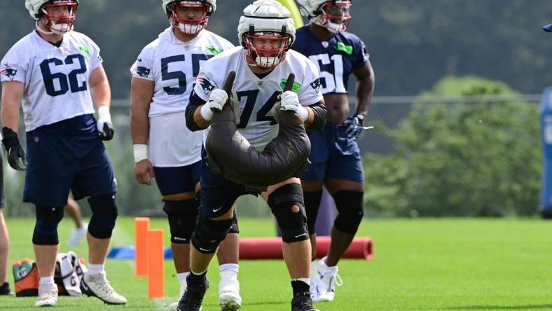 Jul 27, 2023; Foxborough, MA, USA; New England Patriots offensive tackle Riley Reiff (74) works with a weight bag during training camp at Gillette Stadium. Mandatory Credit: Eric Canha-USA TODAY Sports