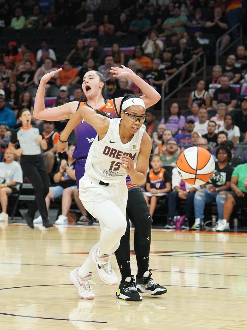 Aug 3, 2023; Phoenix, Arizona, USA; Atlanta Dream guard Allisha Gray (15) chases the ball against Phoenix Mercury center Megan Gustafson (10) during the game at at Footprint Center. Mandatory Credit: Joe Camporeale-USA TODAY Sports