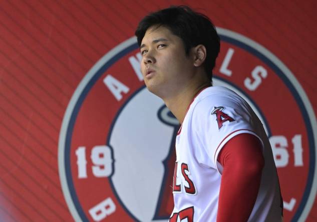 Aug 5, 2023; Anaheim, California, USA; Los Angeles Angels designated hitter Shohei Ohtani (17) looks on from the dugout during the game against the Seattle Mariners at Angel Stadium. Mandatory Credit: Jayne Kamin-Oncea-USA TODAY Sports