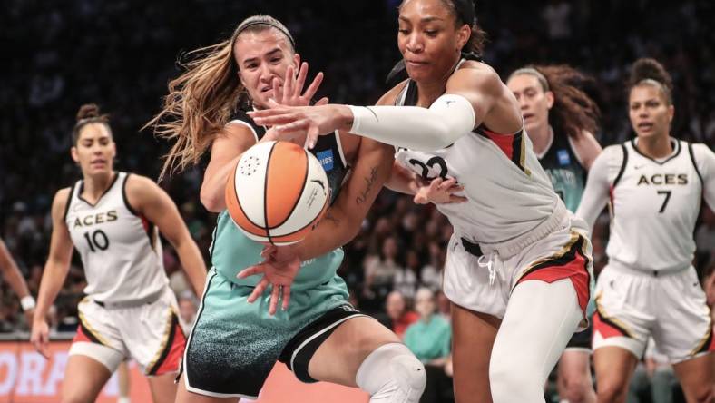 Aug 6, 2023; Brooklyn, New York, USA;  New York Liberty guard Sabrina Ionescu (20) and Las Vegas Aces forward A'ja Wilson (22) fight for a loose ball in the first quarter at Barclays Center. Mandatory Credit: Wendell Cruz-USA TODAY Sports