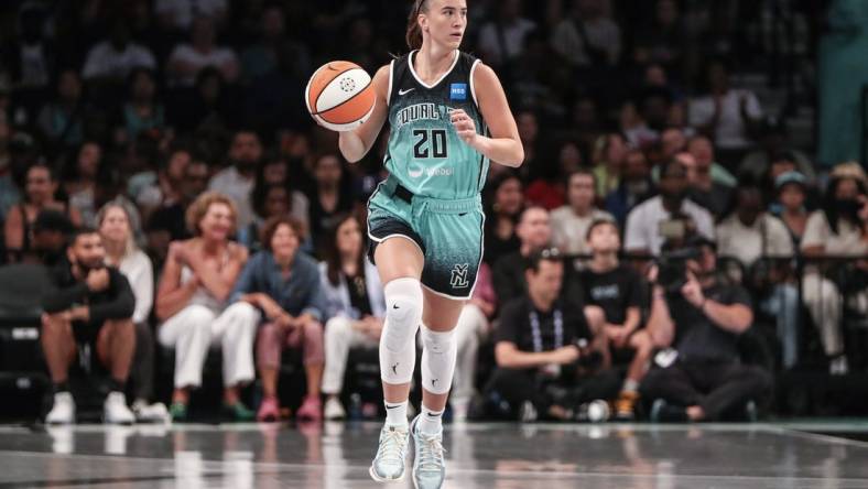 Aug 6, 2023; Brooklyn, New York, USA; New York Liberty guard Sabrina Ionescu (20) brings the ball up in the first quarter against the Las Vegas Aces at Barclays Center. Mandatory Credit: Wendell Cruz-USA TODAY Sports