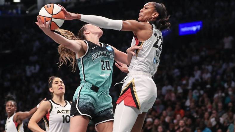 Aug 6, 2023; Brooklyn, New York, USA;  Las Vegas Aces forward A'ja Wilson (22) blocks a shot taken by New York Liberty guard Sabrina Ionescu (20) in the first quarter at Barclays Center. Mandatory Credit: Wendell Cruz-USA TODAY Sports
