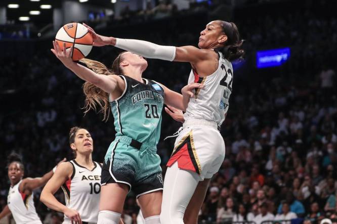 Aug 6, 2023; Brooklyn, New York, USA;  Las Vegas Aces forward A'ja Wilson (22) blocks a shot taken by New York Liberty guard Sabrina Ionescu (20) in the first quarter at Barclays Center. Mandatory Credit: Wendell Cruz-USA TODAY Sports