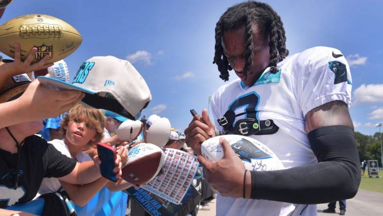 The Carolina Panthers and the New York Jets held a joint training camp practice at Wofford in Spartanburg on Aug. 9, 2023. Jaycee Horn (8) of the Carolina Panthers signs gear for fans.