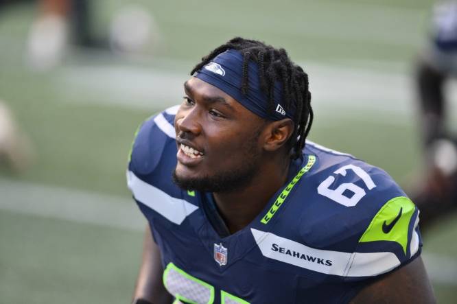 Seattle Seahawks tackle Charles Cross (67) warms up before playing against  the Los Angeles Rams in