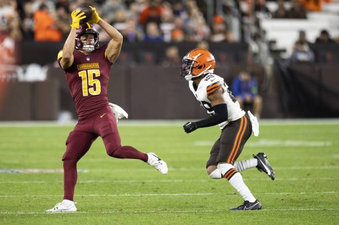Aug 11, 2023; Cleveland, Ohio, USA; Washington Commanders wide receiver Dax Milne (15) makes a reception under coverage by Cleveland Browns cornerback Cameron Mitchell (29) during the third quarter at Cleveland Browns Stadium. Mandatory Credit: Scott Galvin-USA TODAY Sports