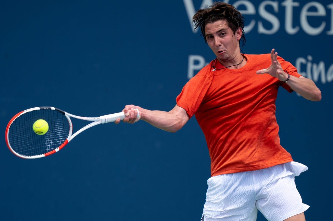 Alexander Shevchenko, of Russia, returns to M  rton Fucsovics, of Hungary, during the Western & Southern Open qualifying round in Cincinnati on Saturday, Aug. 12, 2023.