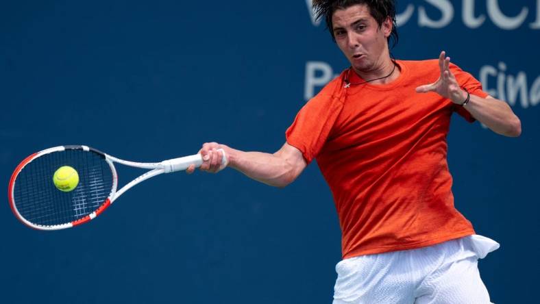 Alexander Shevchenko, of Russia, returns to M  rton Fucsovics, of Hungary, during the Western & Southern Open qualifying round in Cincinnati on Saturday, Aug. 12, 2023.