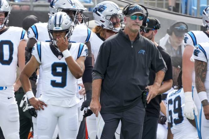 Aug 12, 2023; Charlotte, North Carolina, USA; Carolina Panthers head coach Frank Reich stands on the sideline with quarterback Bryce Young (9) during the first quarter against the New York Jets at Bank of America Stadium. Mandatory Credit: Jim Dedmon-USA TODAY Sports