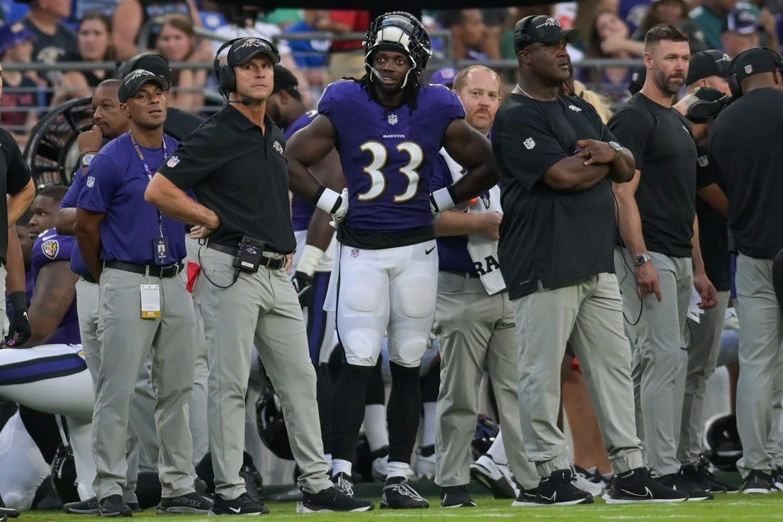 Aug 12, 2023; Baltimore, Maryland, USA;  Baltimore Ravens head coach John Harbaugh stands with running back Melvin Gordon III (33) during the first half against the Philadelphia Eagles  at M&T Bank Stadium. Mandatory Credit: Tommy Gilligan-USA TODAY Sports