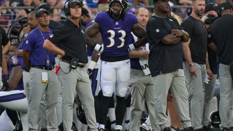 Aug 12, 2023; Baltimore, Maryland, USA;  Baltimore Ravens head coach John Harbaugh stands with running back Melvin Gordon III (33) during the first half against the Philadelphia Eagles  at M&T Bank Stadium. Mandatory Credit: Tommy Gilligan-USA TODAY Sports