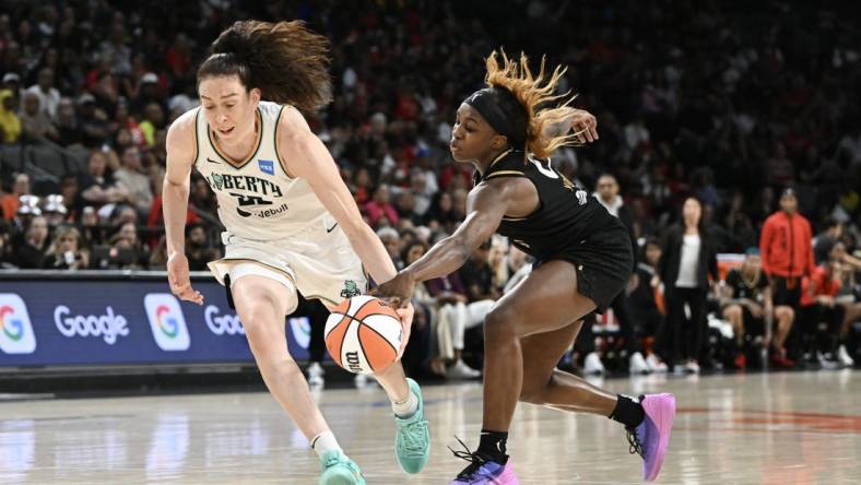 Aug 15, 2023; Las Vegas, Nevada, USA; New York Liberty forward Breanna Stewart (30) has the ball stripped by Las Vegas Aces guard Jackie Young (0) during the second quarter at Michelob Ultra Arena. Mandatory Credit: Candice Ward-USA TODAY Sports