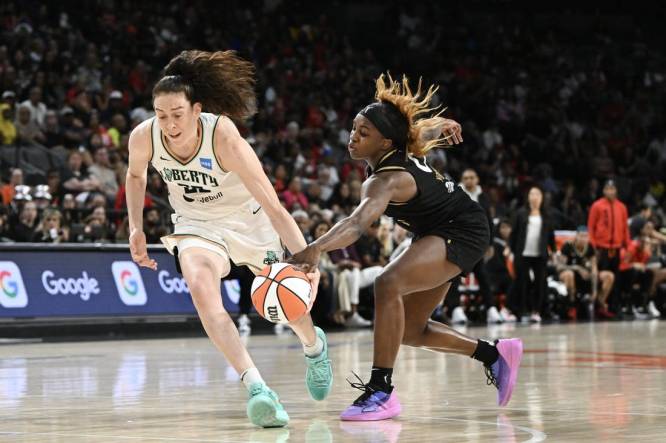 Aug 15, 2023; Las Vegas, Nevada, USA; New York Liberty forward Breanna Stewart (30) has the ball stripped by Las Vegas Aces guard Jackie Young (0) during the second quarter at Michelob Ultra Arena. Mandatory Credit: Candice Ward-USA TODAY Sports