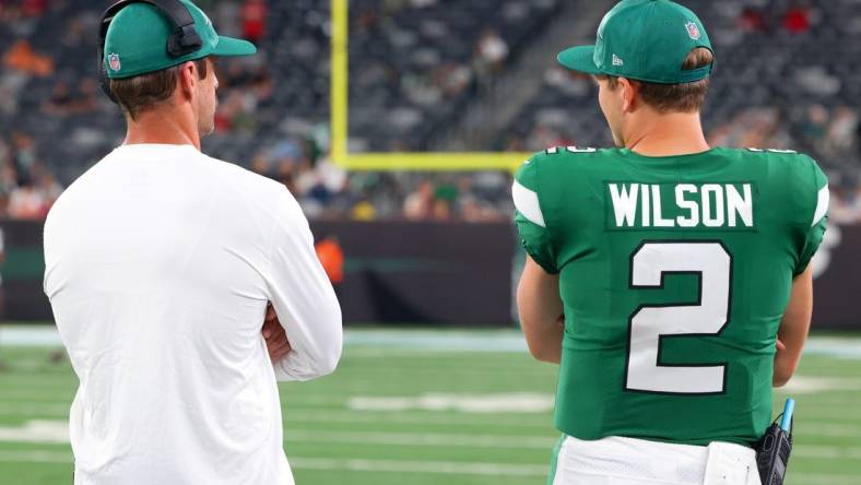 Aug 19, 2023; East Rutherford, New Jersey, USA; New York Jets quarterback Aaron Rodgers (8) and New York Jets quarterback Zach Wilson (2) talk during the second half of their game against the Tampa Bay Buccaneers at MetLife Stadium. Mandatory Credit: Ed Mulholland-USA TODAY Sports